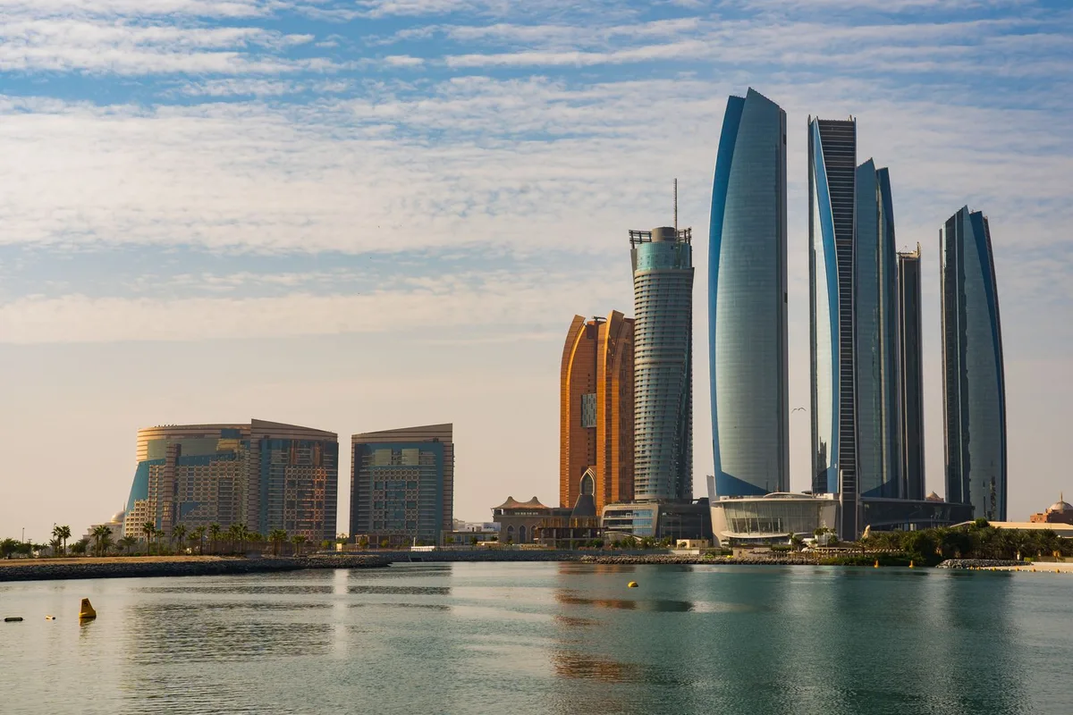 Etihad Towers and the Corniche waterfront in late afternoon light