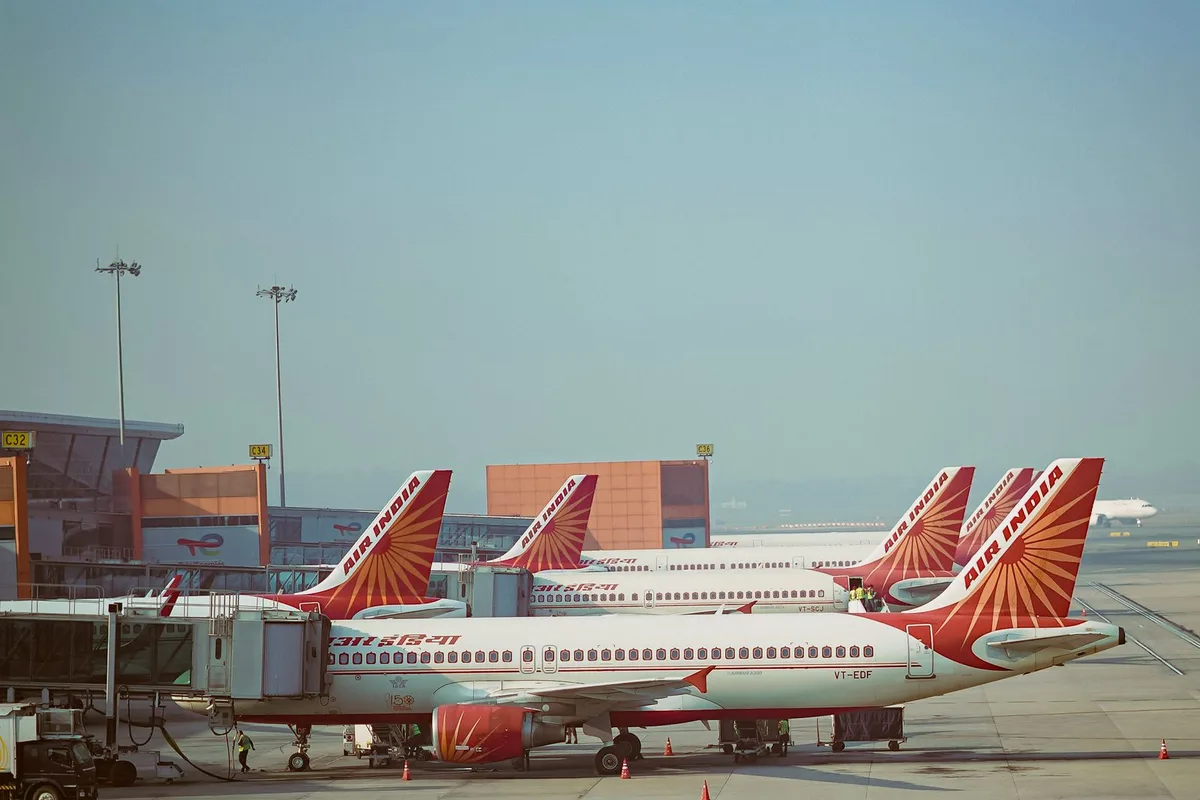 Air India jets on the apron at Delhi airport in pale morning haze