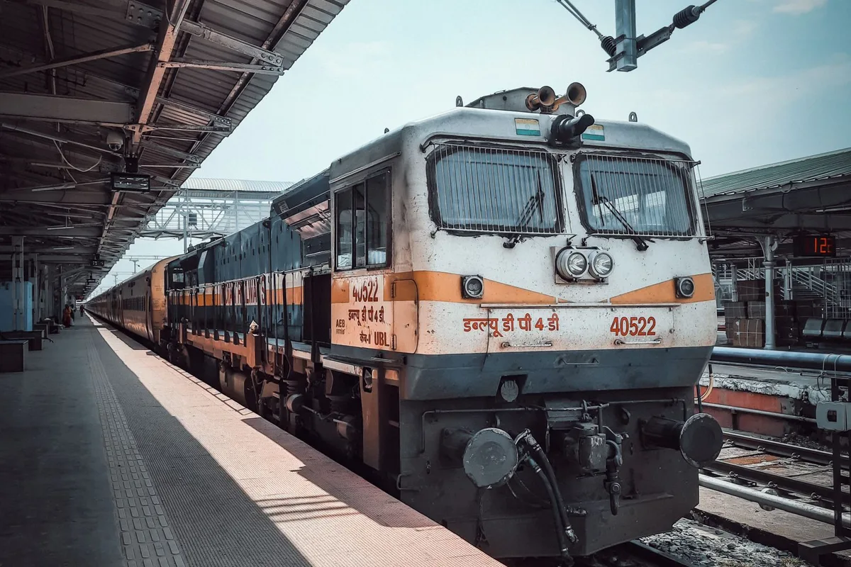 An Indian Railways express locomotive drawing into a station platform