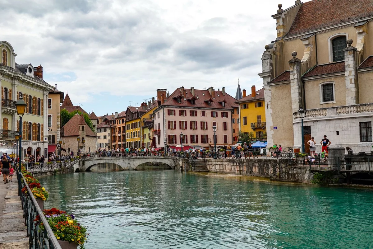 The Thiou river flowing past old town houses and the church in Annecy