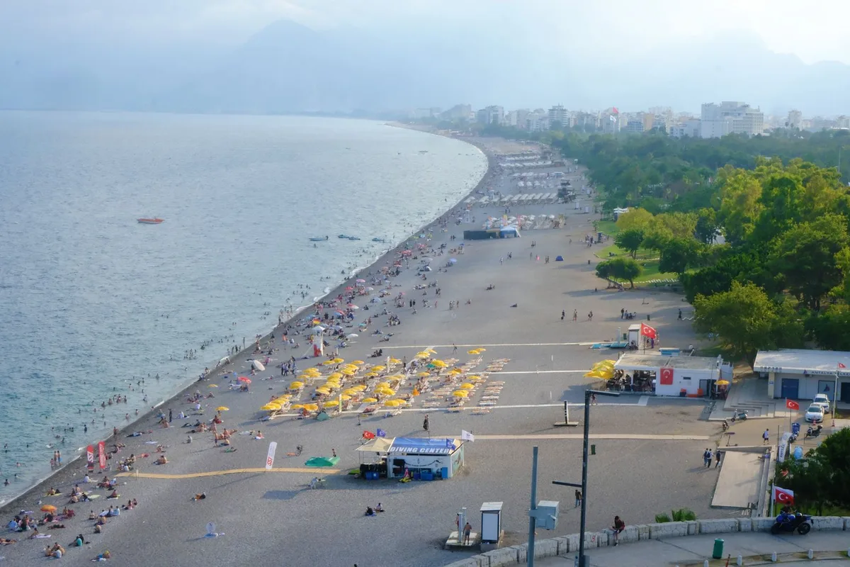 Sunbathers and umbrellas on Konyaaltı beach, Antalya's city beach