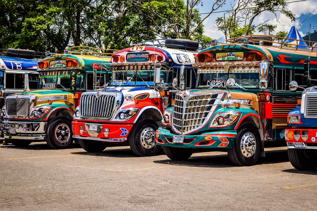 Painted chicken buses lined up in Antigua Guatemala