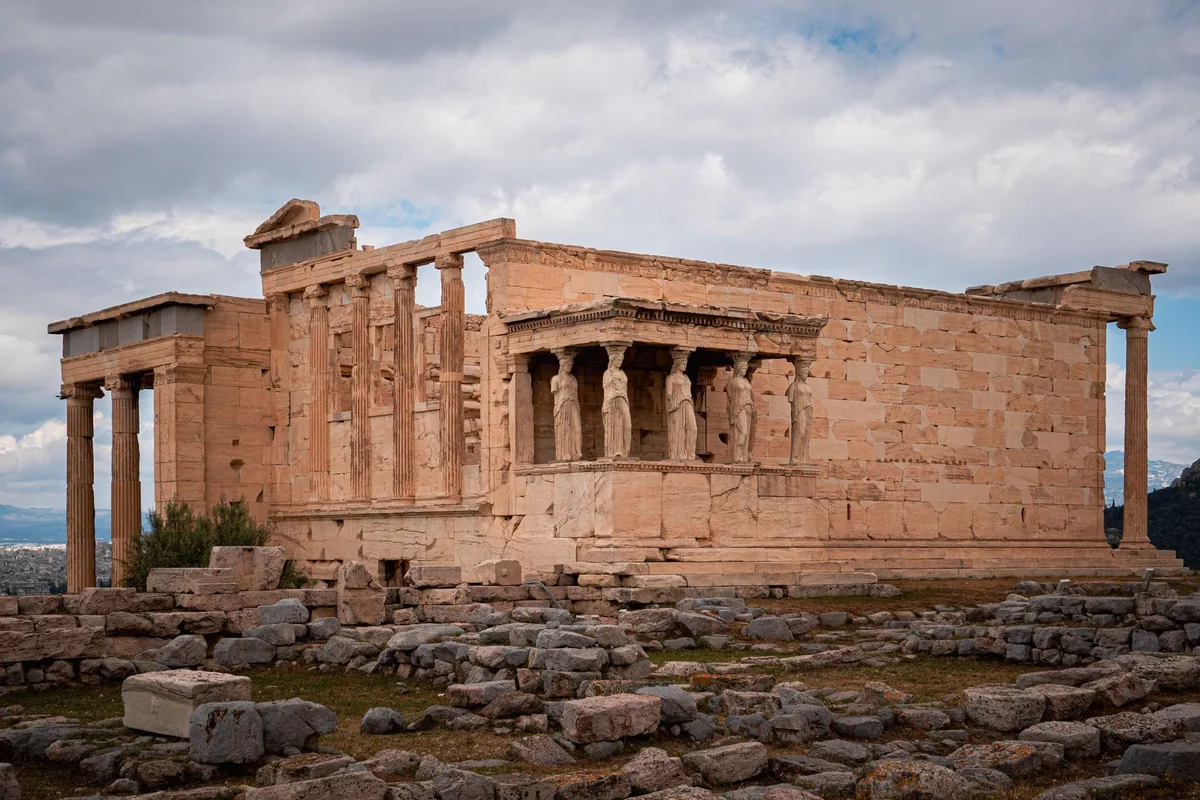 The Erechtheion and its Caryatid porch under a heavy sky
