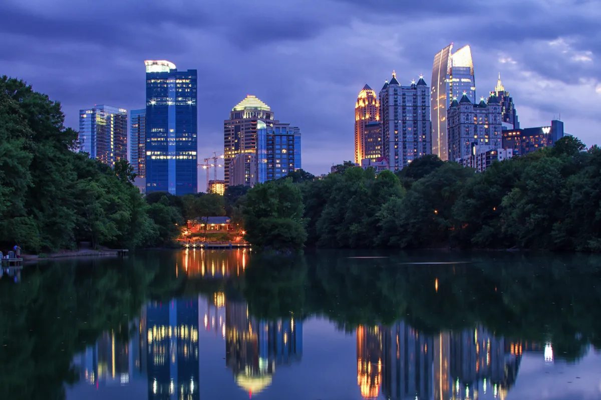 Midtown Atlanta skyline over Lake Clara Meer in Piedmont Park at dusk