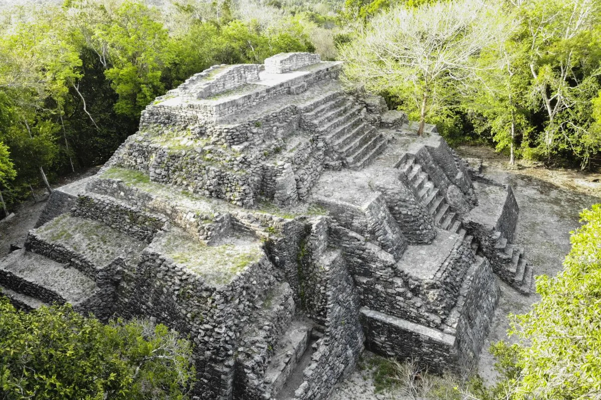 A stepped stone pyramid at Ichkabal, rising out of the jungle