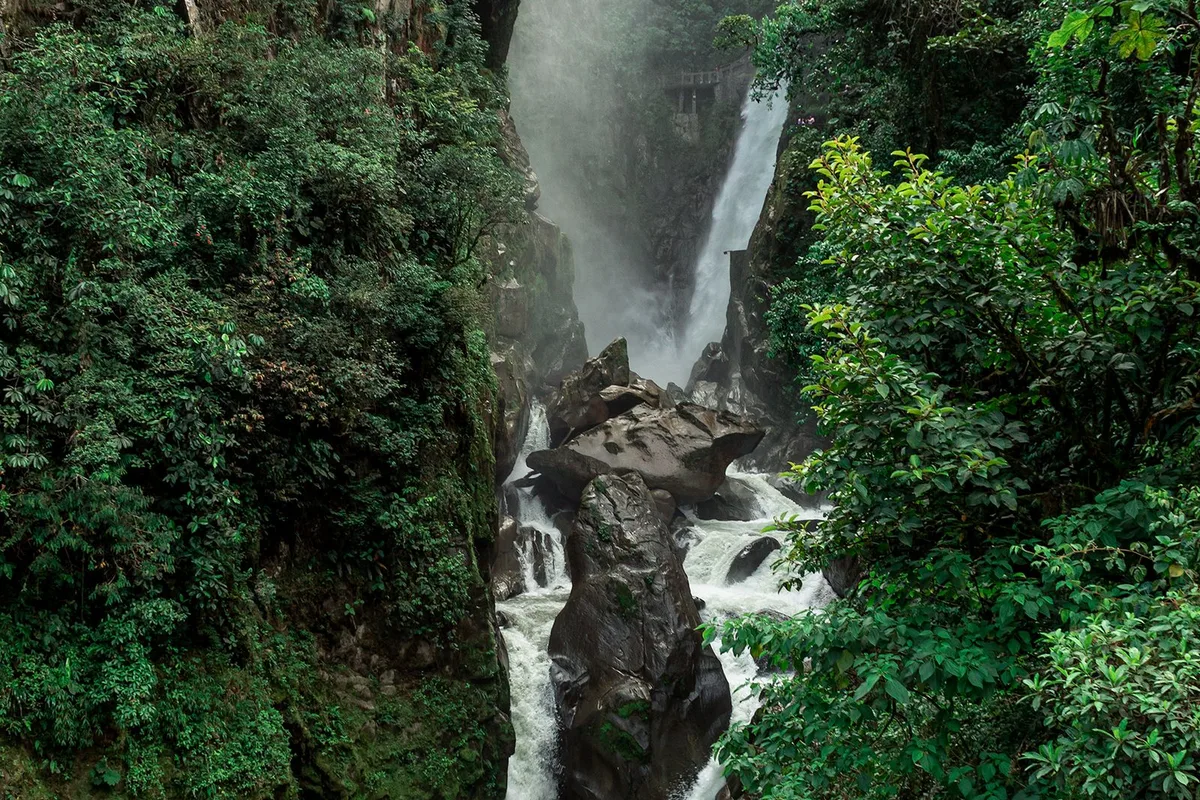 A waterfall dropping through the green gorge on the Ruta de las Cascadas
