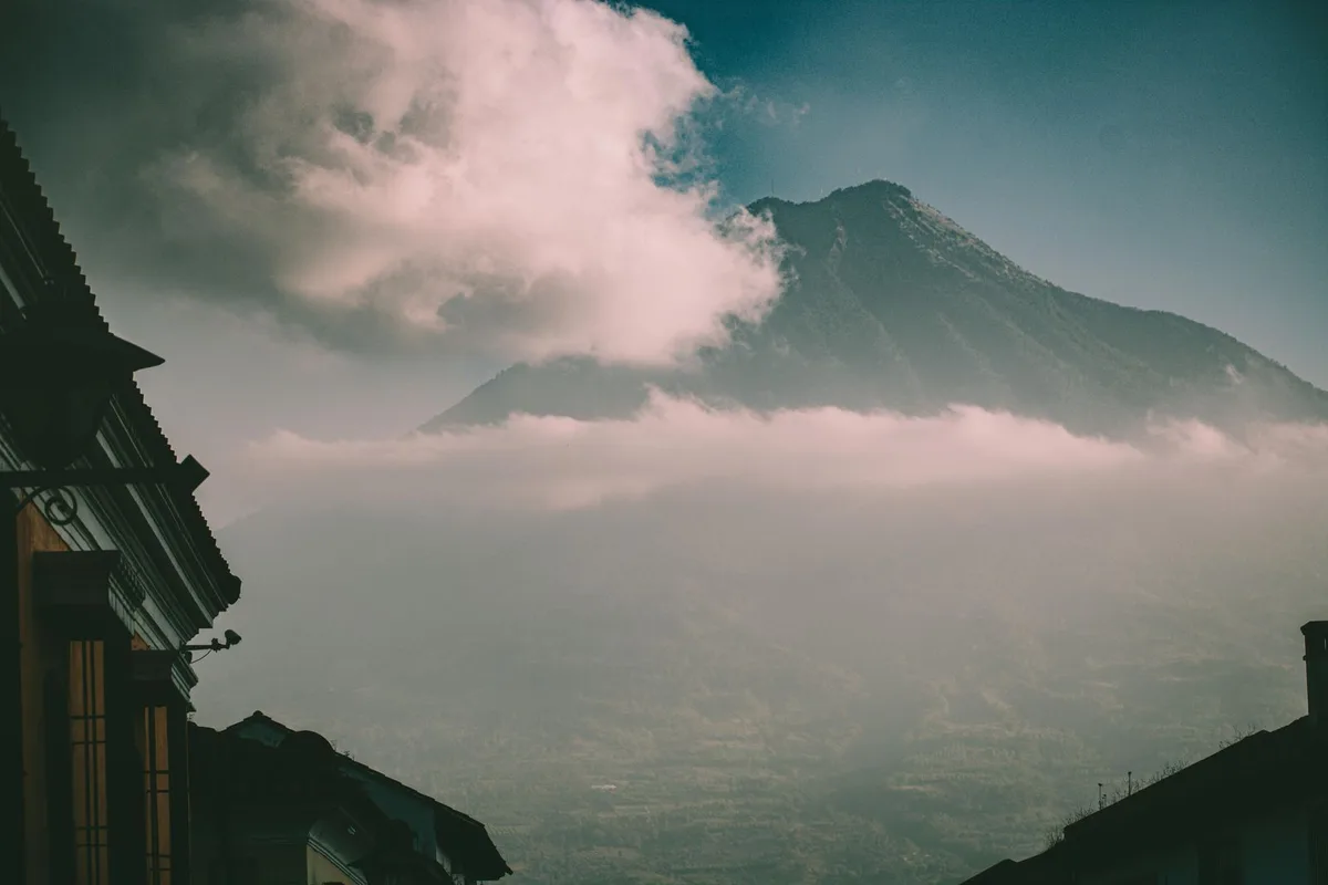 Tungurahua volcano wrapped in cloud above Baños