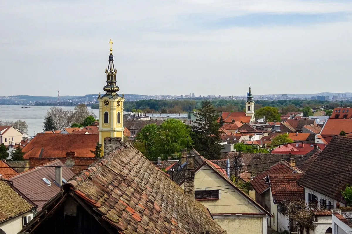 Zemun's red rooftops and church towers above the Danube, from Gardoš hill
