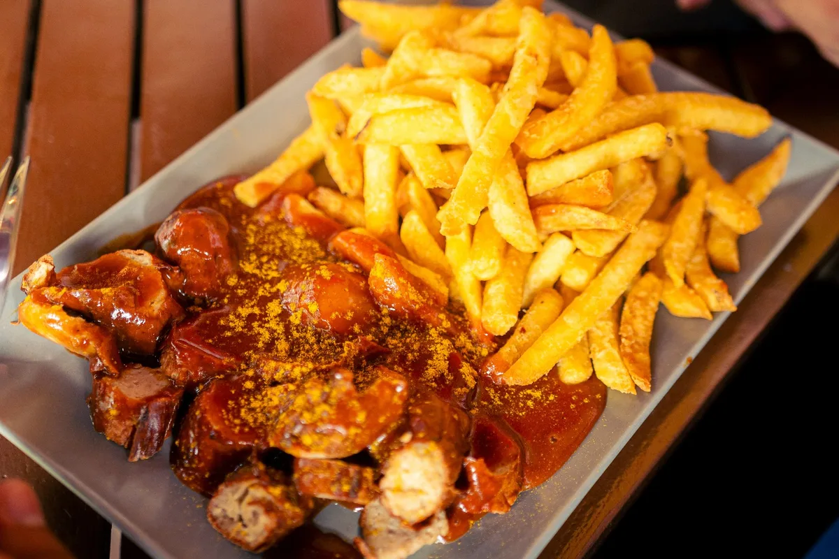 Currywurst and fries on a tray at a Berlin snack stand