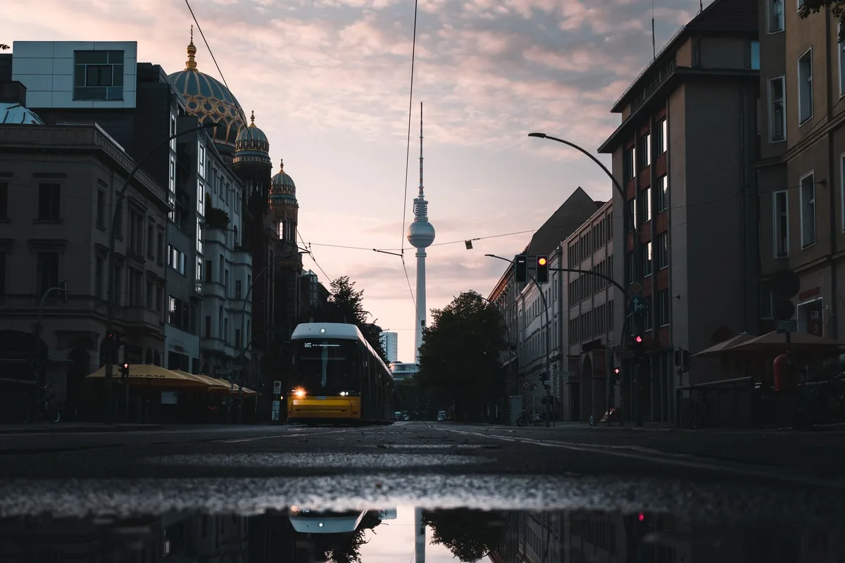 A Berlin street at dusk with the TV Tower at the end of it