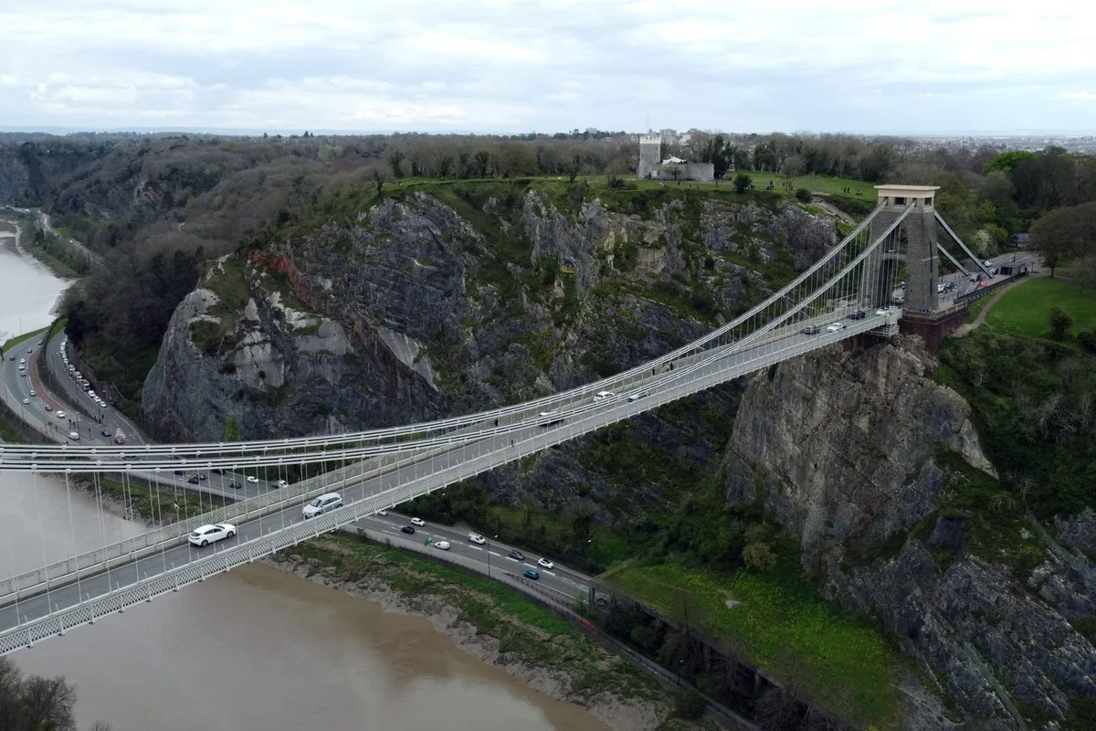 The Clifton Suspension Bridge spanning the Avon Gorge in Bristol, seen from the air above the river