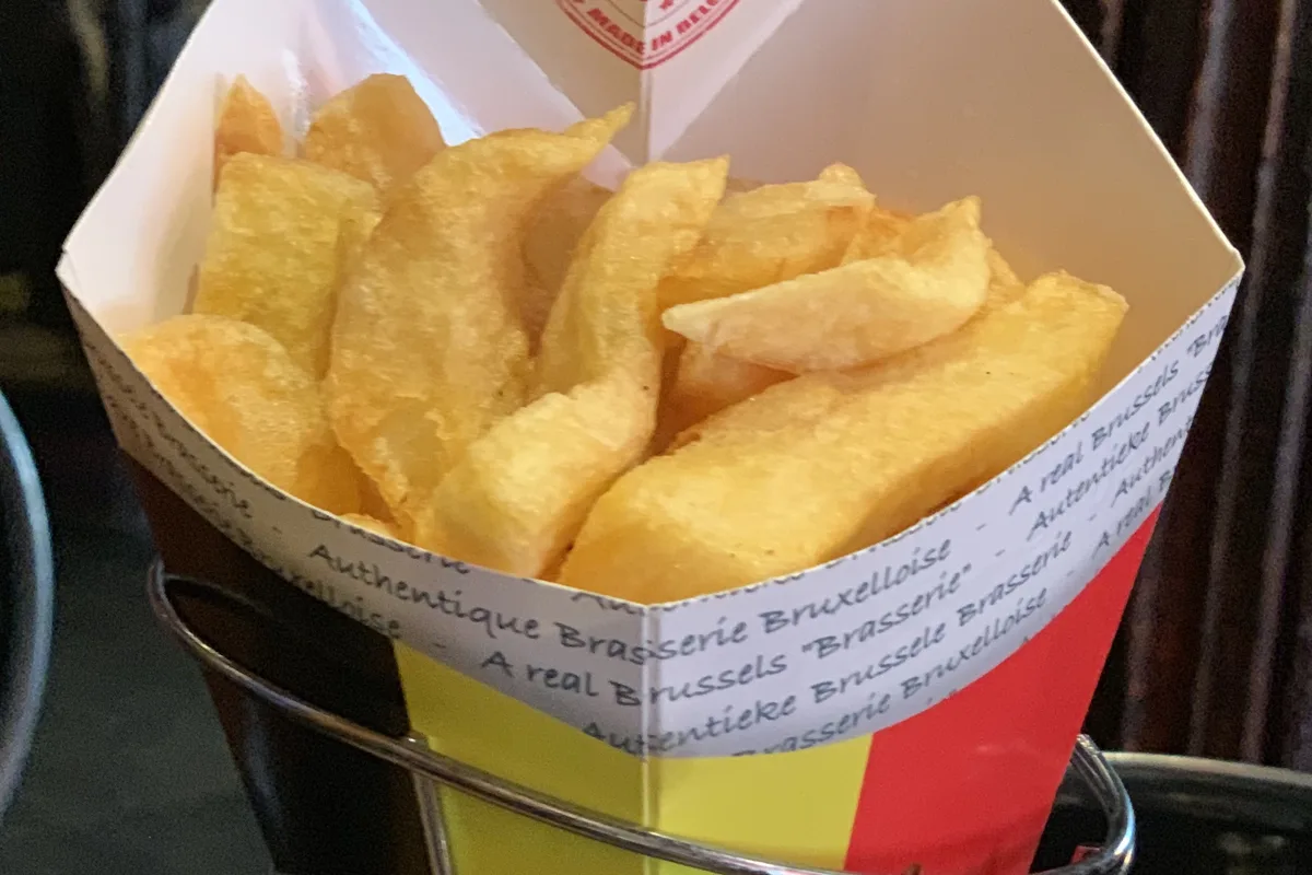 A paper cornet of frites at a Brussels brasserie
