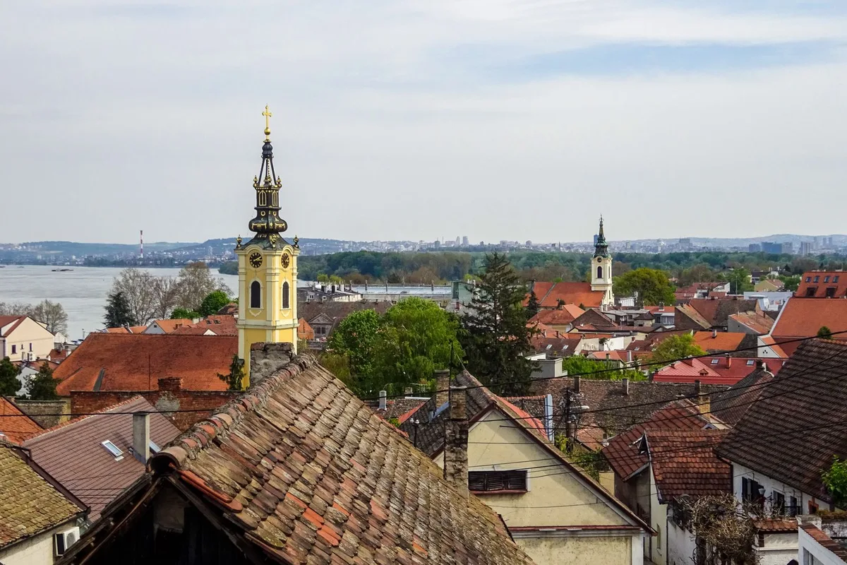 Church towers and rooftops above Szentendre, with the Danube behind