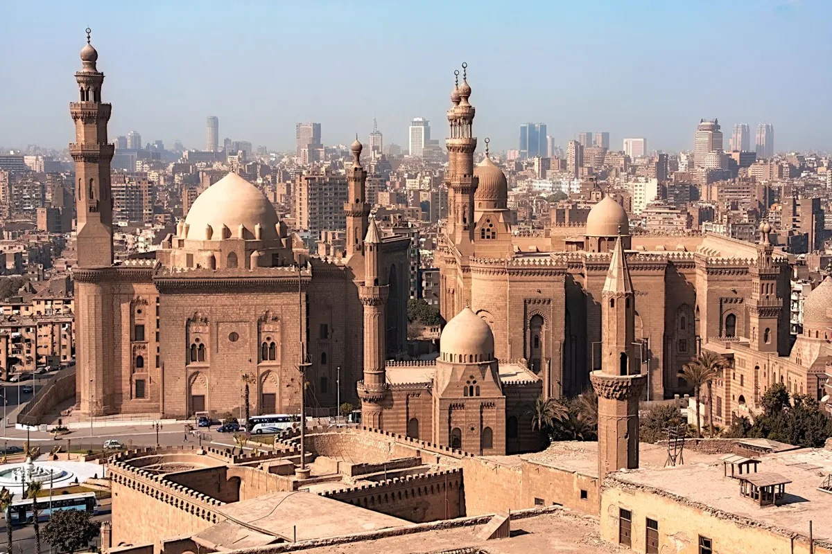 Mosques and minarets above the rooftops of Cairo at dusk