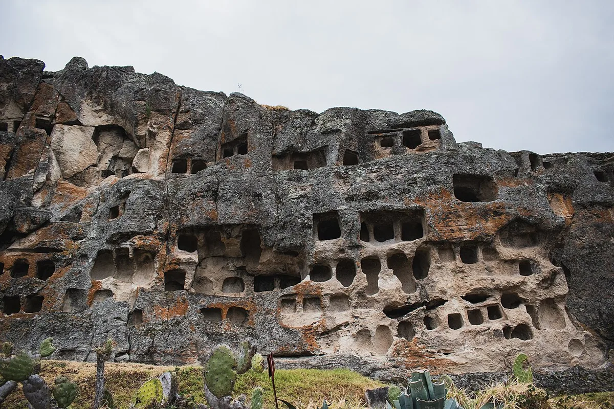 Burial niches carved into the volcanic cliff at the Ventanillas de Otuzco