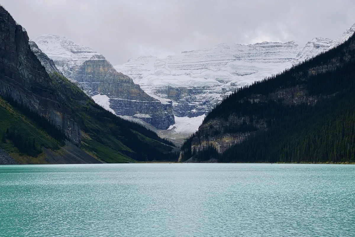 Lake Louise under the Victoria Glacier, the turquoise water flat in the morning
