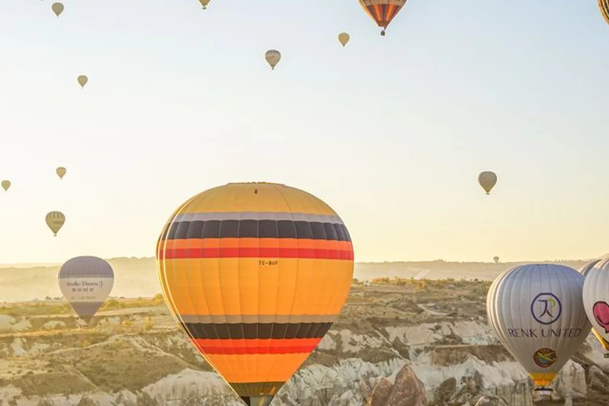 Hot air balloons rising over the Göreme valleys at sunrise, Cappadocia