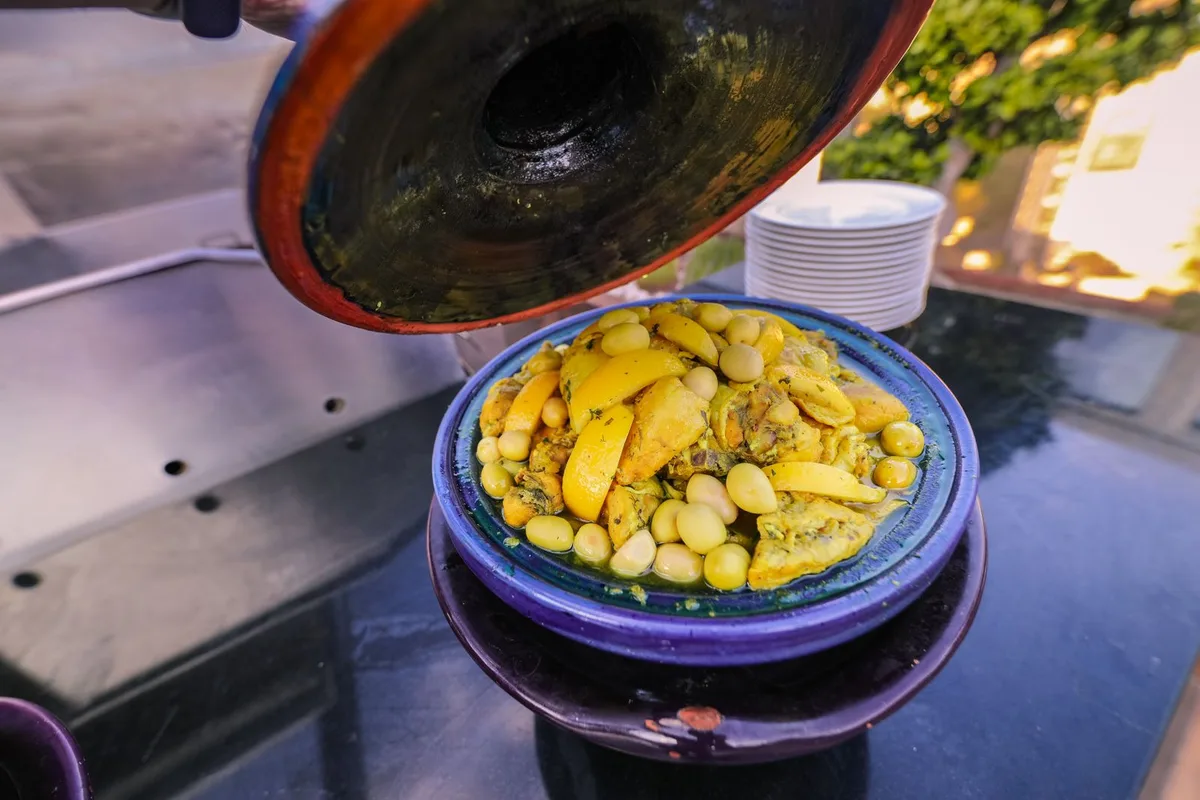 Chicken and preserved lemon tagine served in a blue ceramic dish