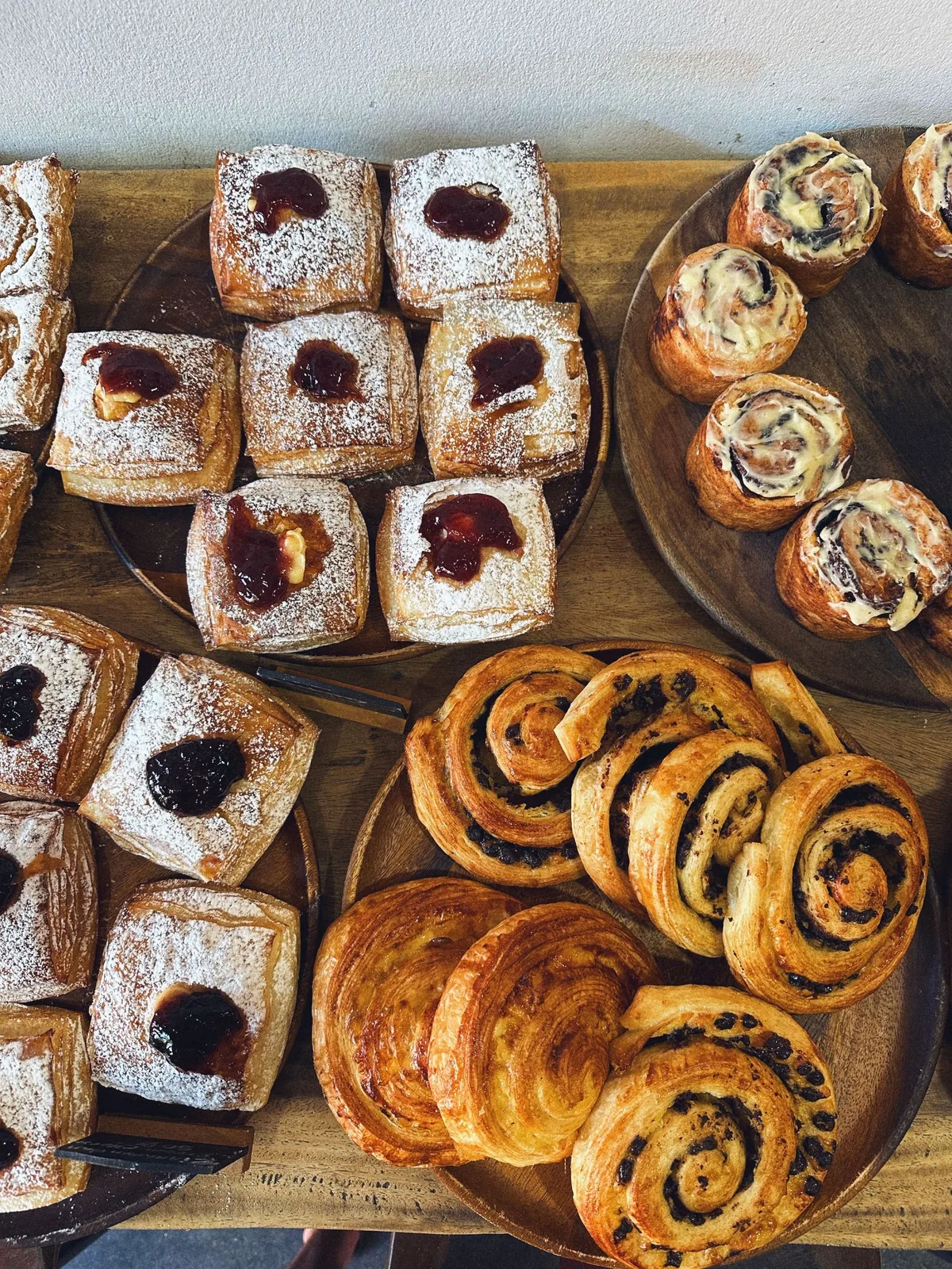 Danish pastries on wooden boards at a bakery