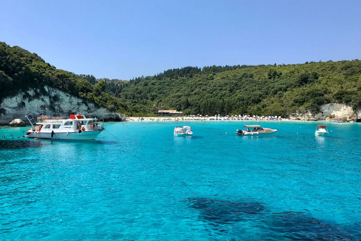 Tour boats at anchor in the turquoise water off Paxos