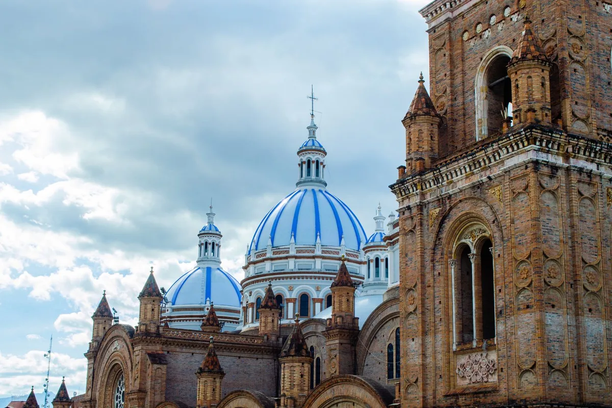 The blue-tiled domes and brick towers of the New Cathedral above Cuenca