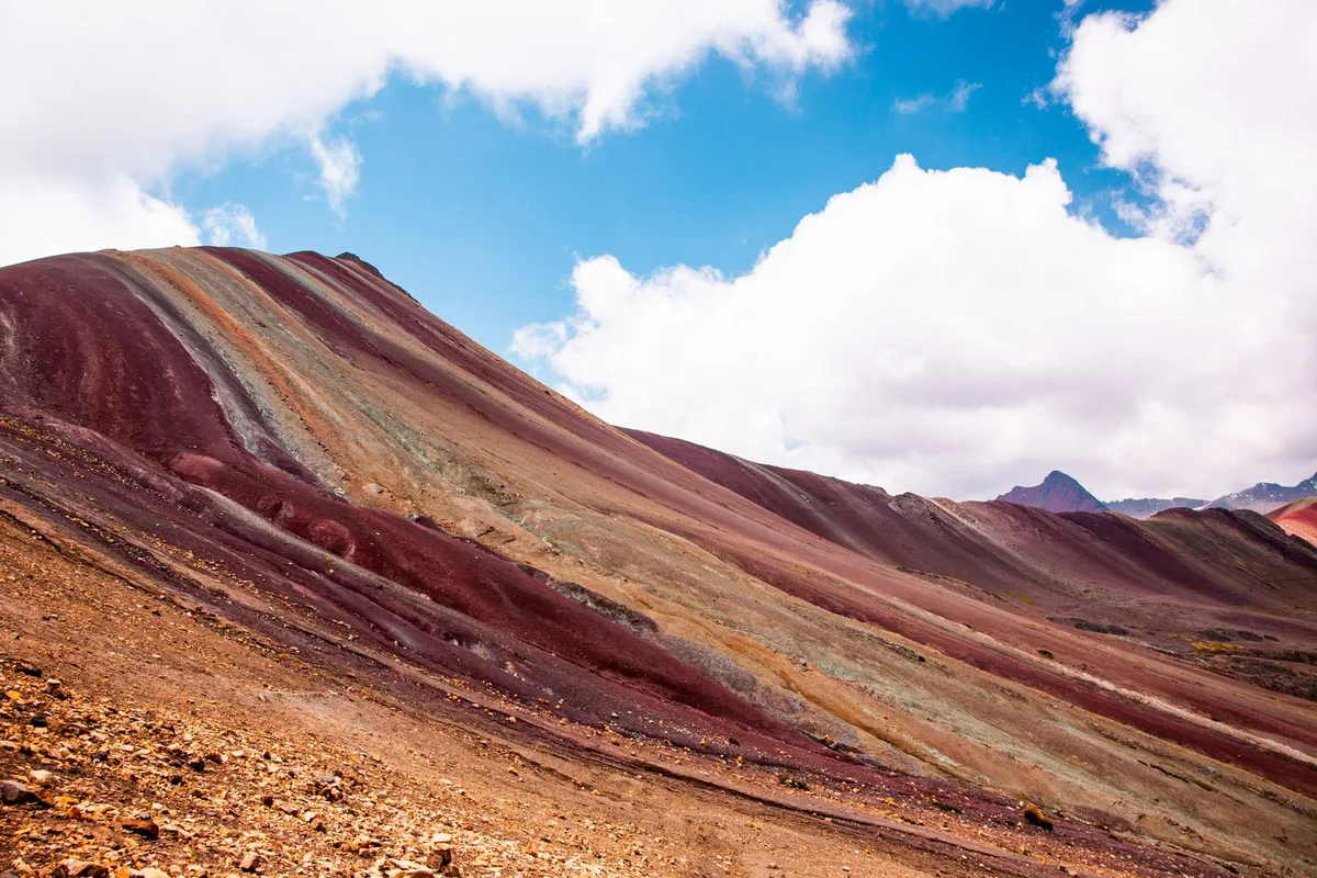 Rainbow Mountain striped slopes under a blue sky