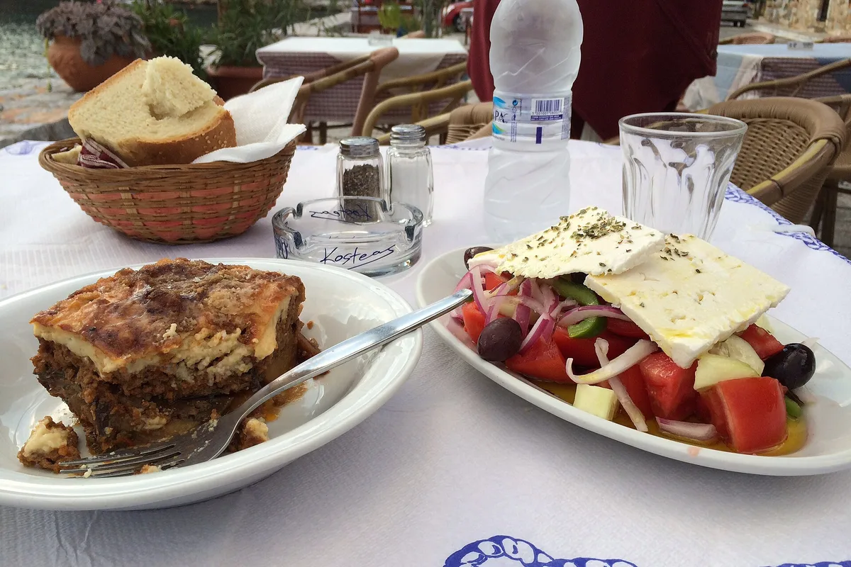 Moussaka and Greek salad on a taverna table