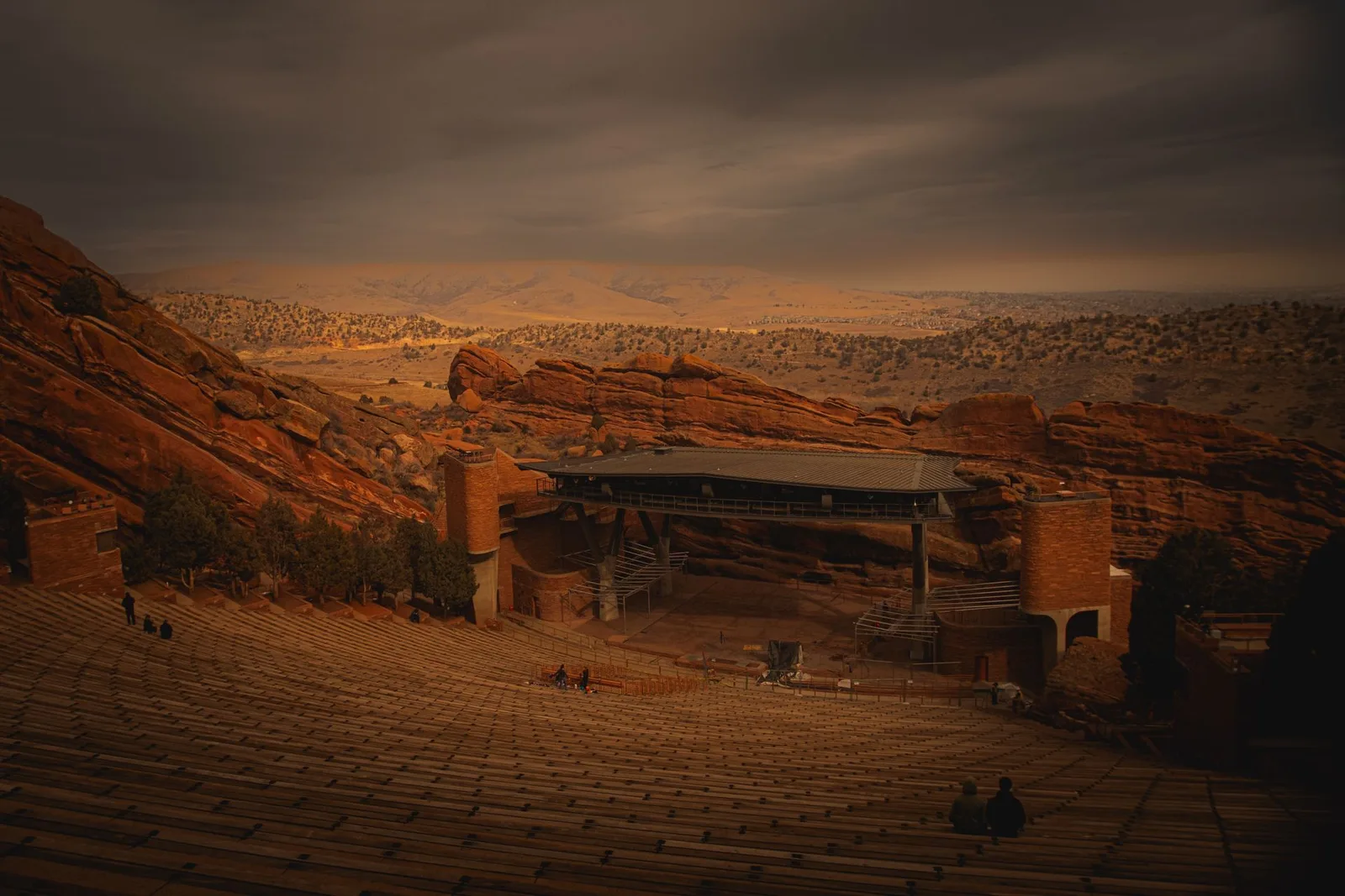 Red Rocks Amphitheatre's stage and empty seats between the red fins at dusk
