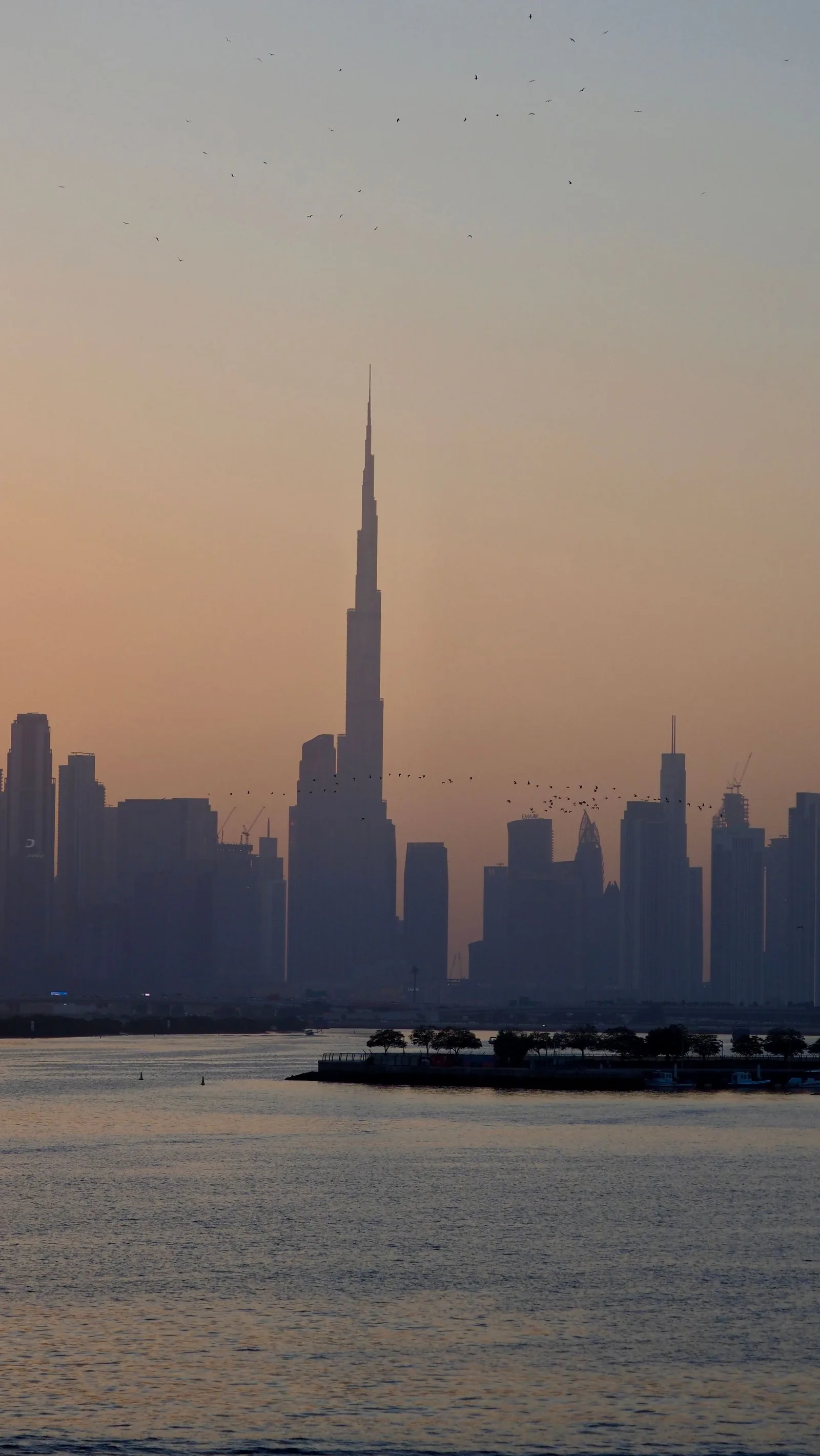 Burj Khalifa silhouetted against the sunset over Dubai