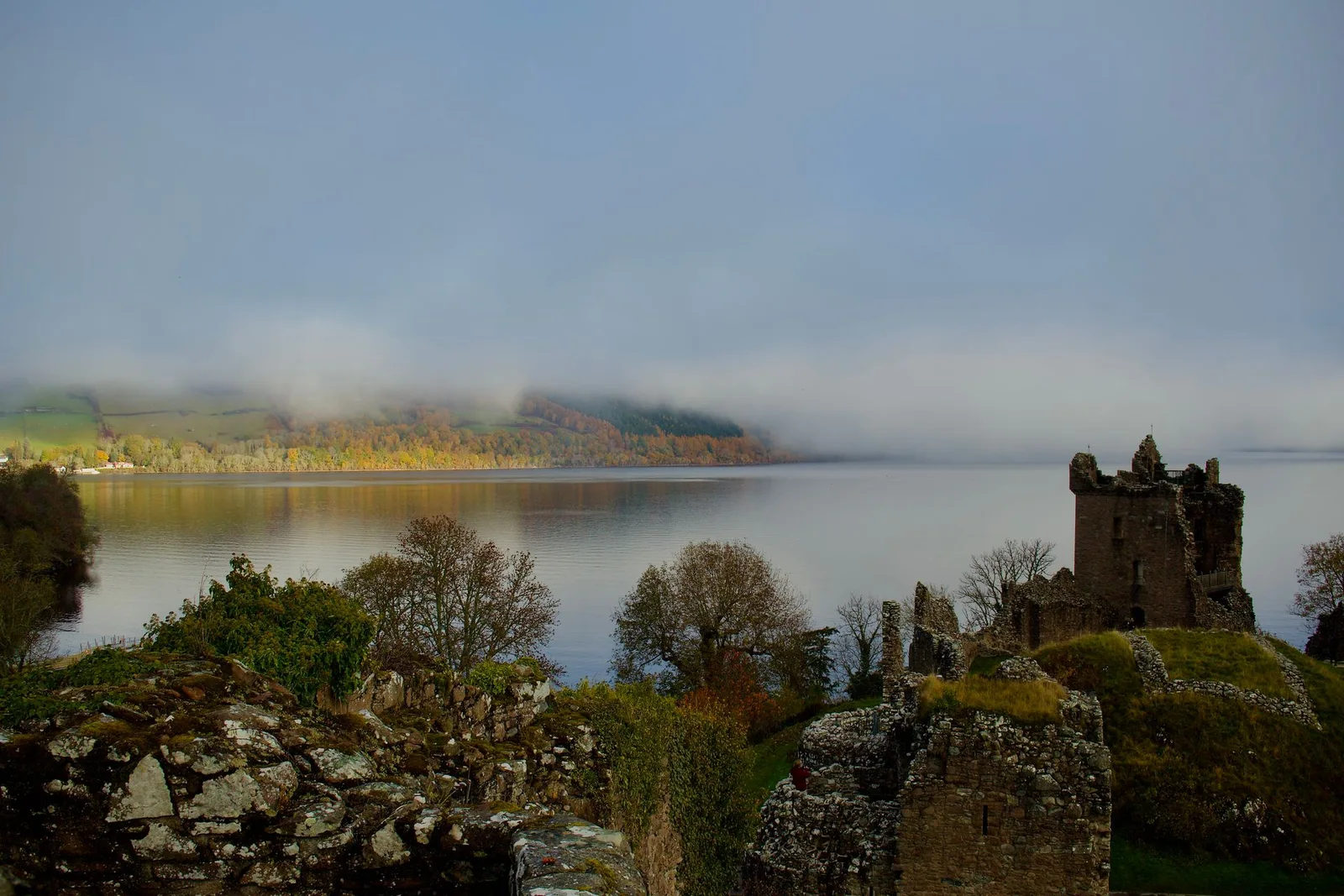 Urquhart Castle ruins above a misty Loch Ness