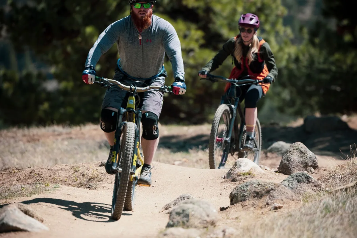 Two cyclists riding a city street on the river valley bike tour