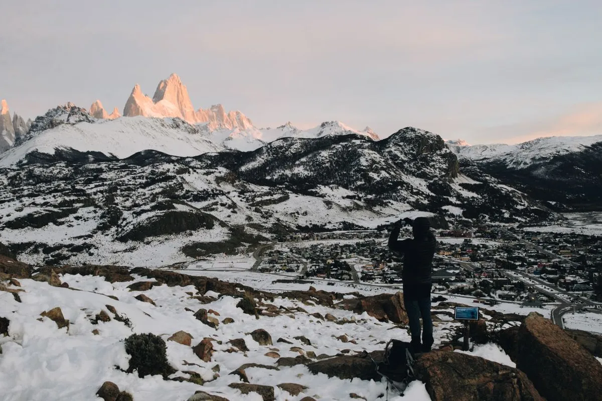 A photographer watching dawn light hit the snowy Fitz Roy range