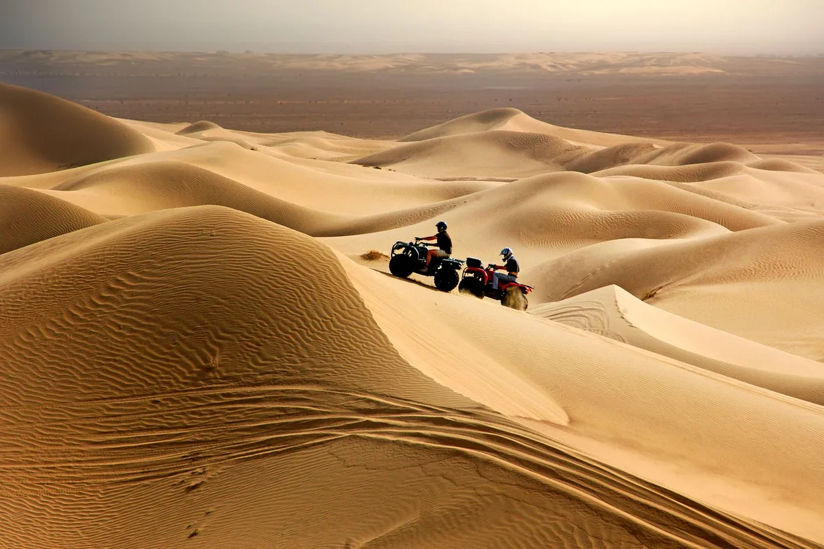 ATVs crossing sand dunes on the off-road trails behind Ensenada