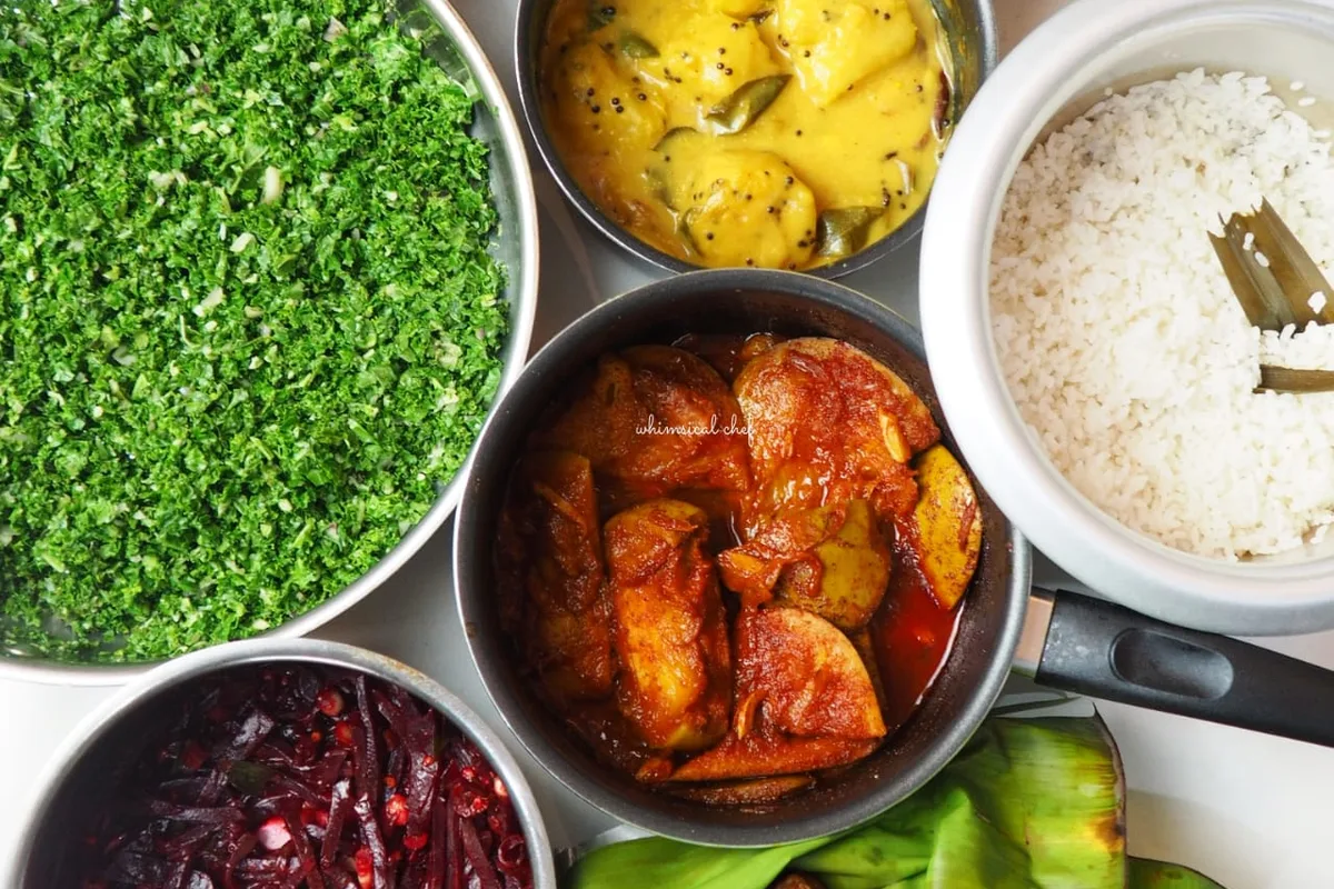 A Sri Lankan rice and curry spread with small bowls of curries and sambols