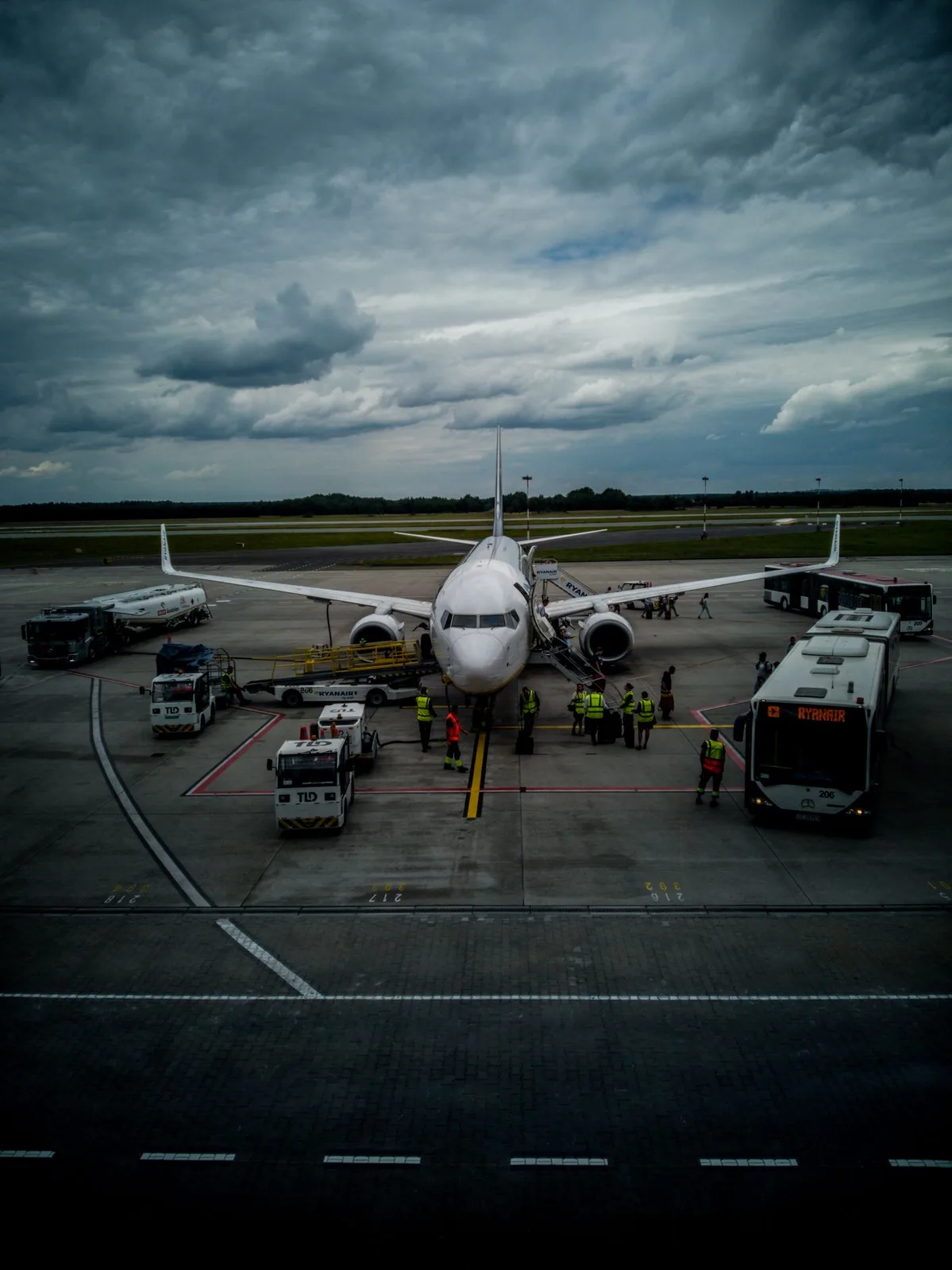 A jet boarding on the apron under a heavy sky