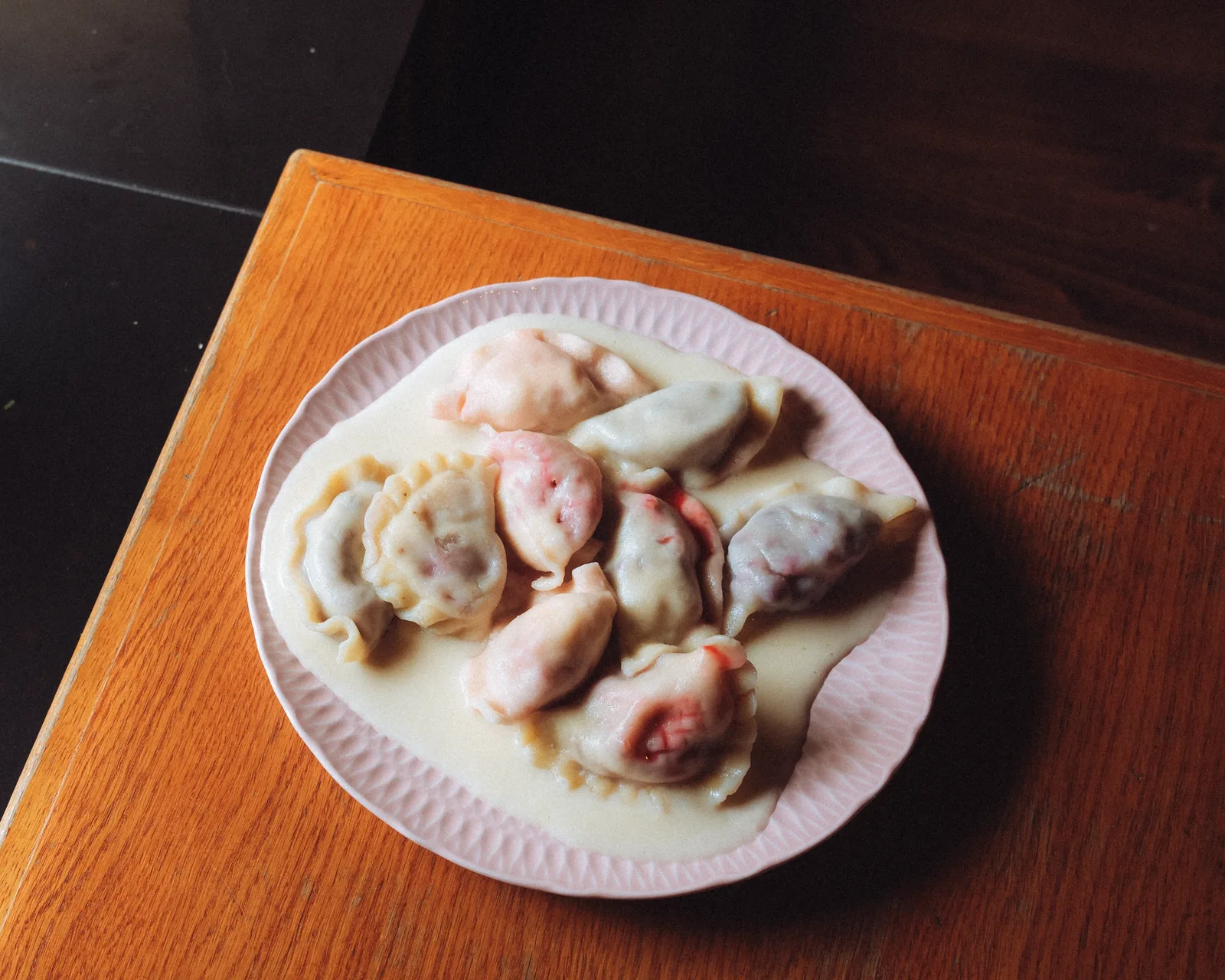 Sweet pierogi with a cream sauce