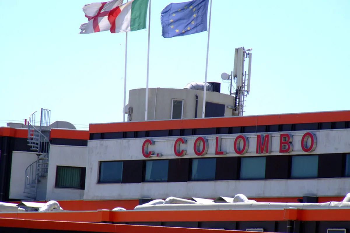 The C. Colombo terminal at Genoa Cristoforo Colombo Airport, the Genoa, Italian and EU flags above the entrance