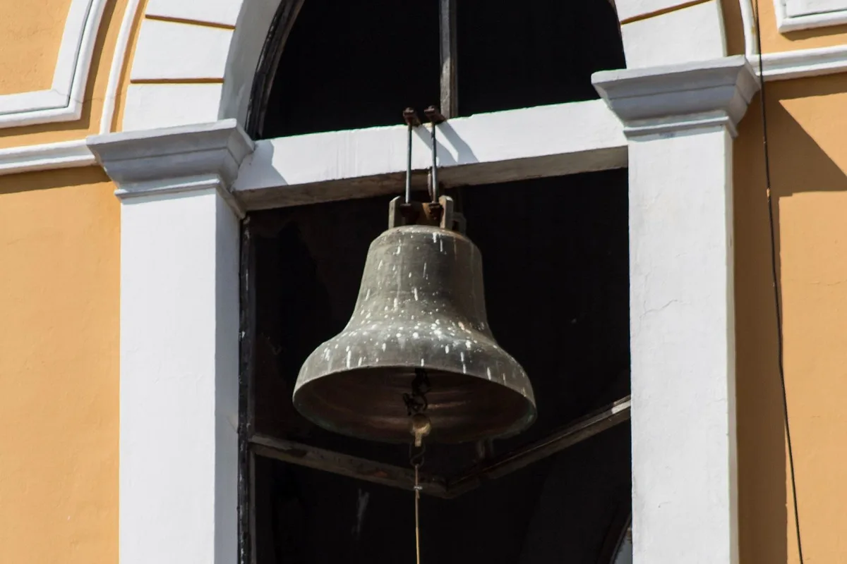 A church bell in an arched window in Granada, Nicaragua