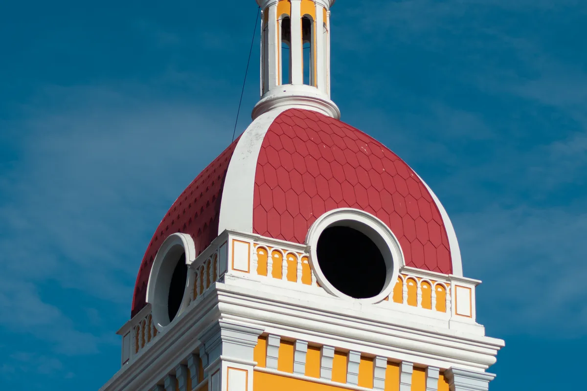 The Granada Cathedral bell tower against a blue sky