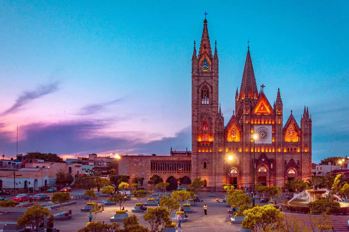 The Templo Expiatorio lit up at dusk in Guadalajara, spires against a pink and blue sky