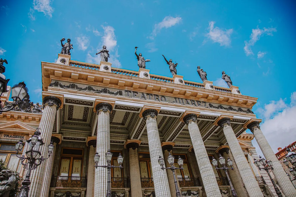 The columned facade of the Teatro Juárez, statues along its roofline