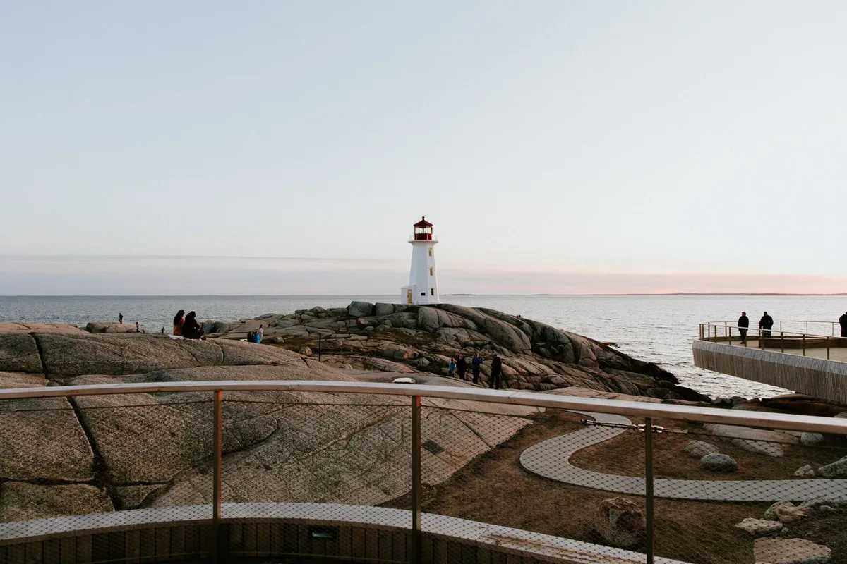 Peggy's Point Lighthouse above the viewing platform and granite shore at Peggy's Cove