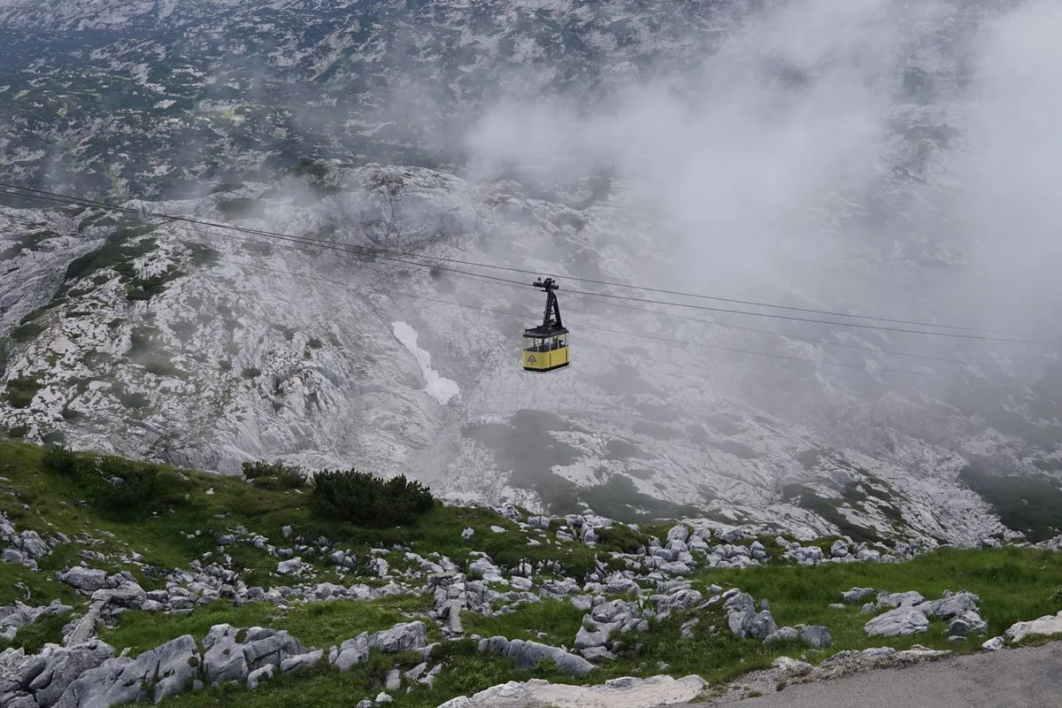 A Dachstein Krippenstein cable car gliding over the rocky plateau in Obertraun