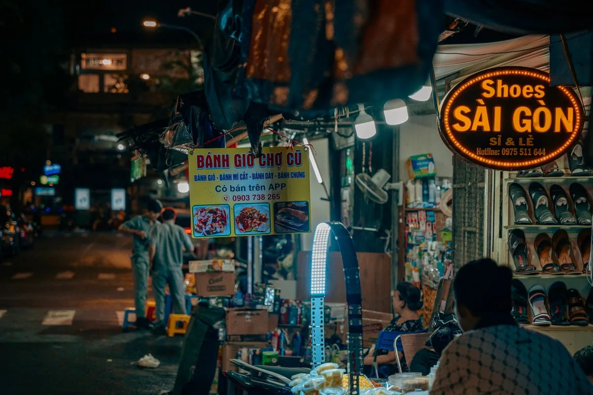 A night-market food stall in Saigon, diners on low plastic stools