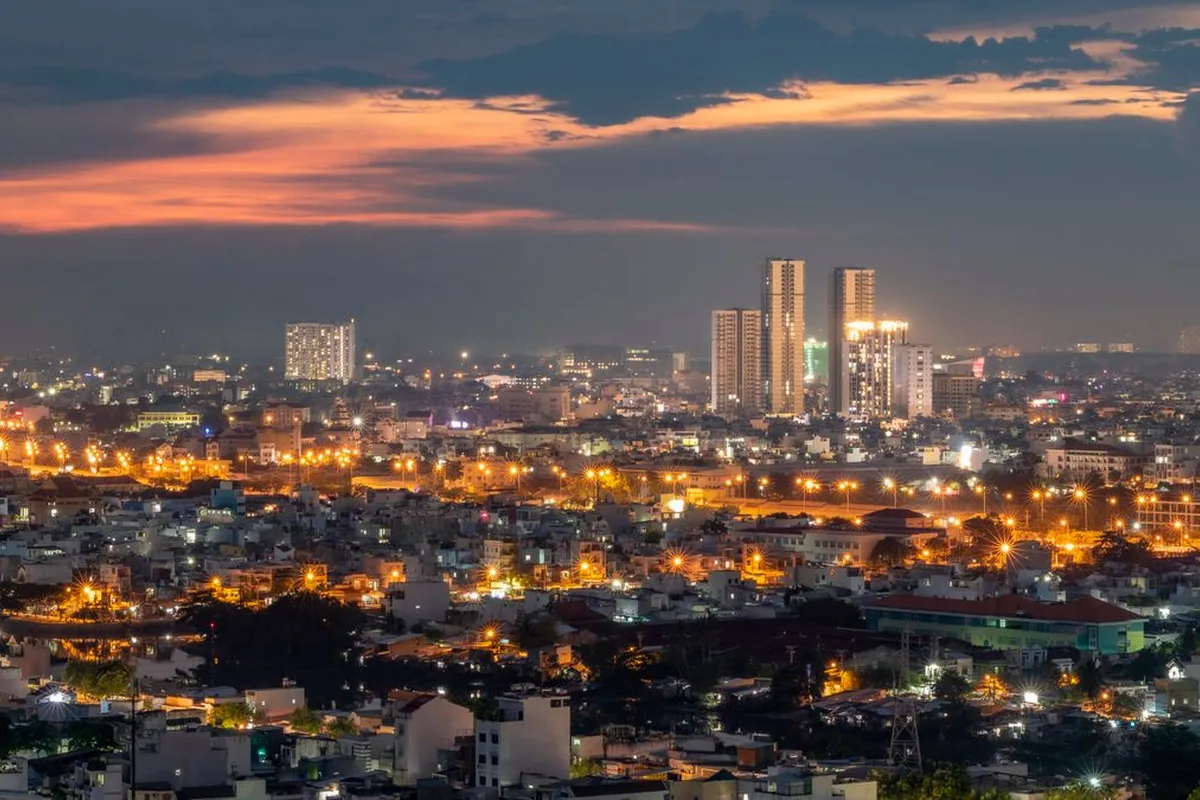 Ho Chi Minh City at dusk, lights coming on across the districts