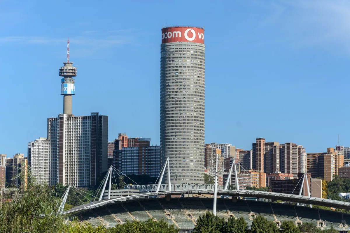 The Johannesburg skyline with the Ponte City tower and Hillbrow Tower above Ellis Park stadium