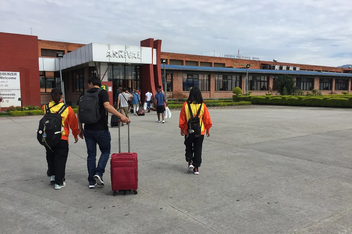 Travellers walking into the arrivals hall at Tribhuvan International Airport