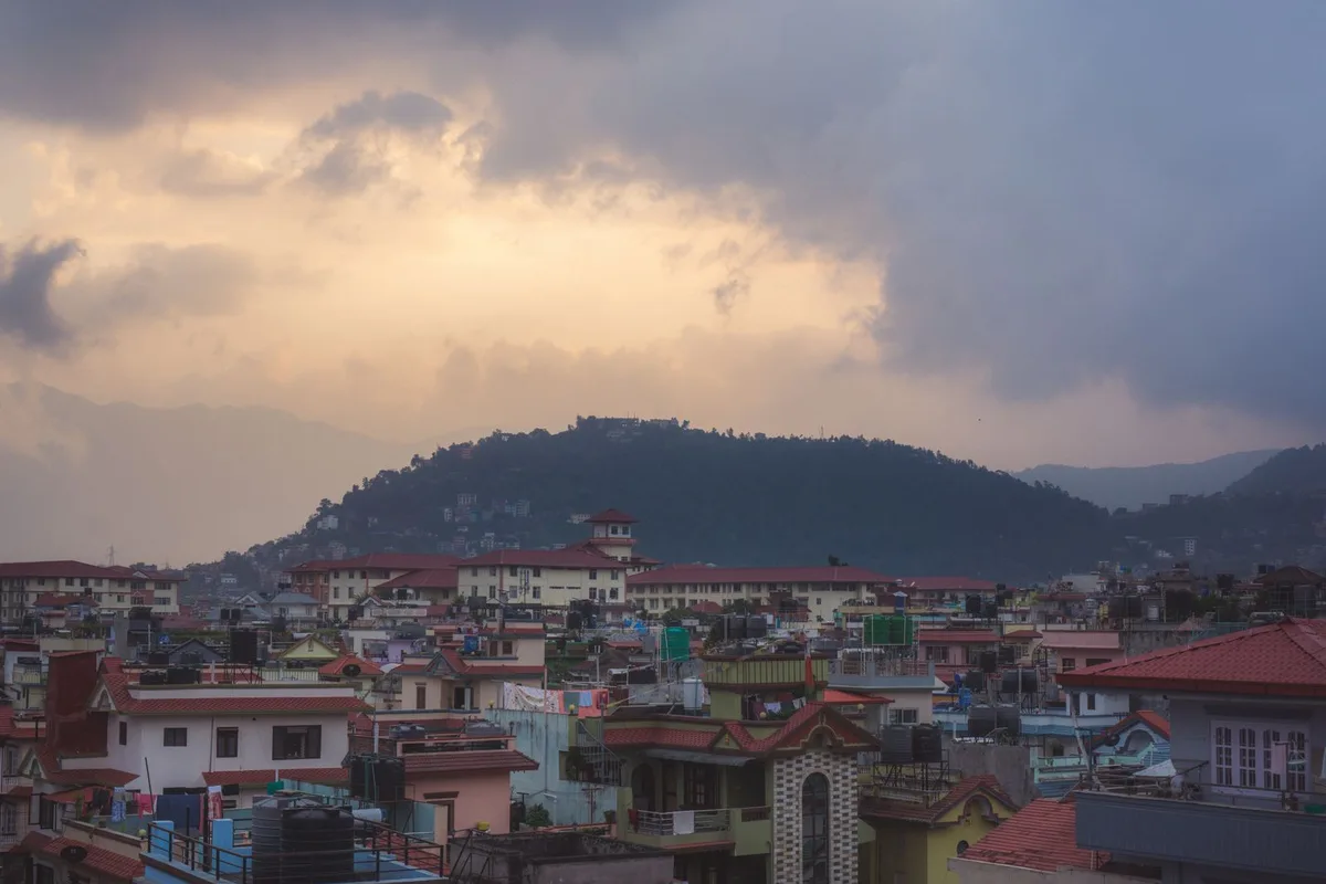 Monsoon clouds gathering over the rooftops and green hills of the Kathmandu Valley
