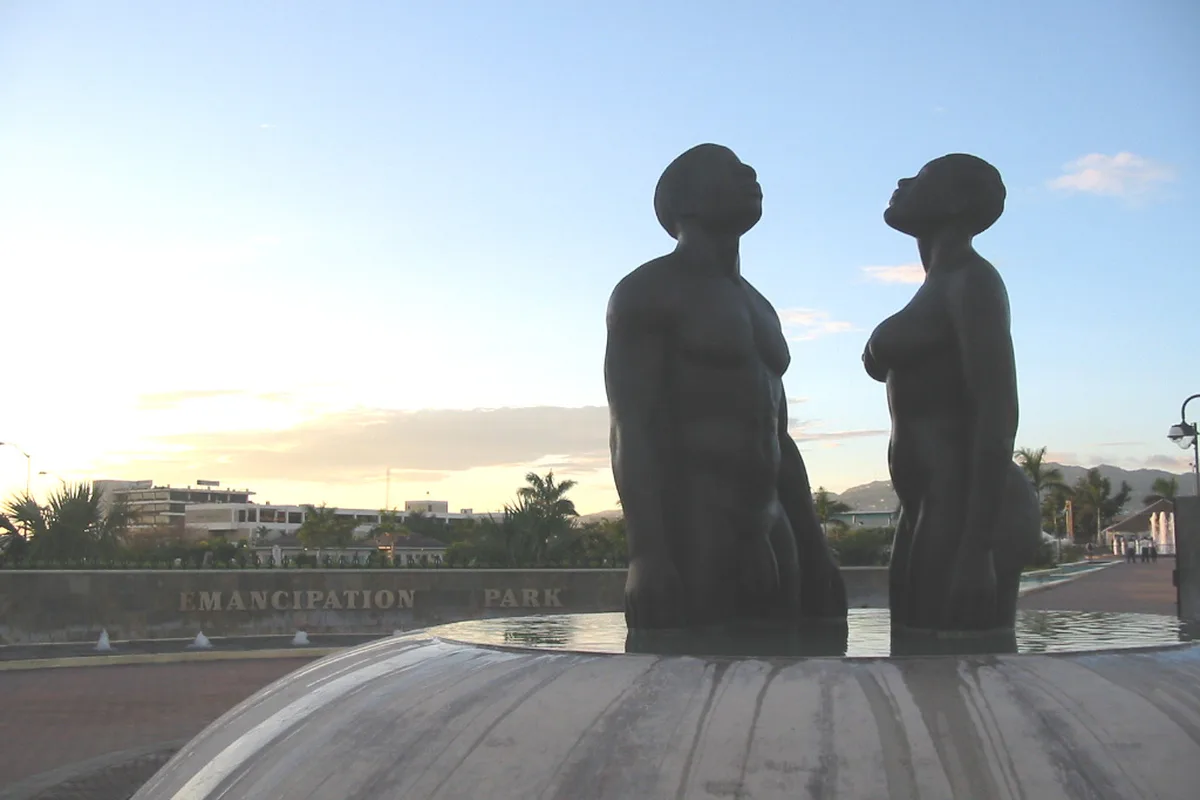 The Redemption Song statues in Emancipation Park, New Kingston, at sunset