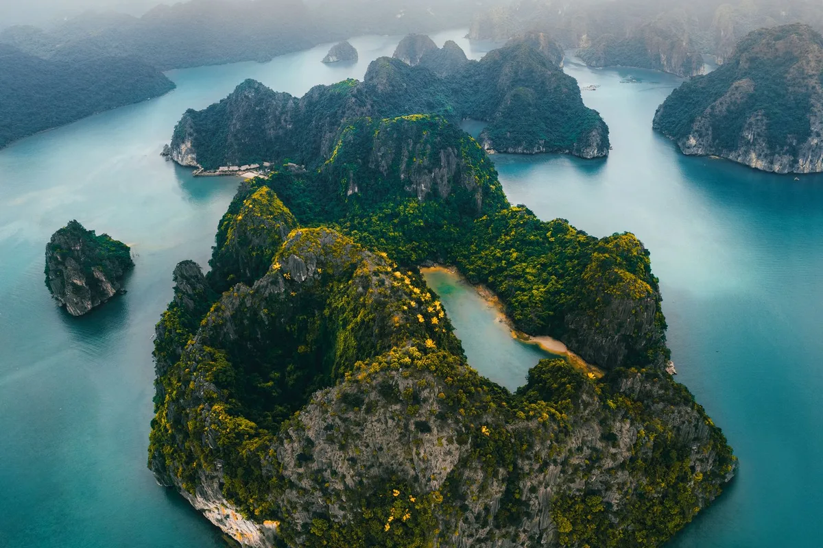 An aerial view of Koh Hong's lagoon, its green water ringed by limestone